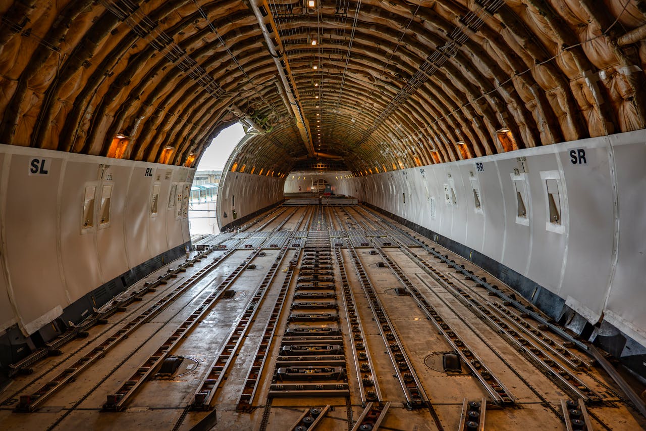 Empty cargo plane interior showcasing spacious hold, ready for freight loading.