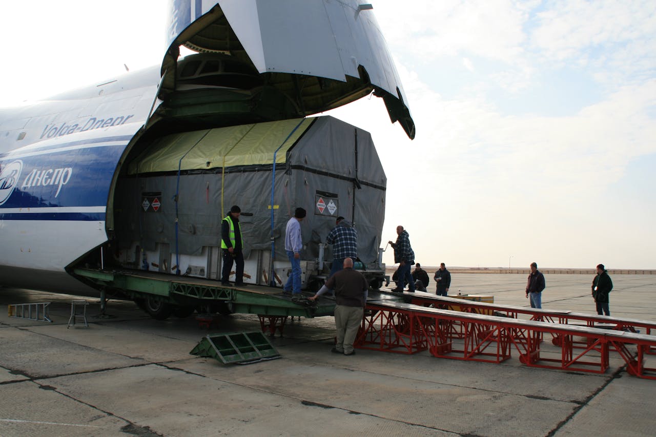 Team unloading cargo from aircraft at Baikonur spaceport.